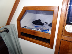 We added a storage area right next to the TV in the main saloon. Below is the DVD Player and above is a storage area wired as a "Charging Station."