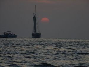 A Conch Navy vessel sailing in to the sunset